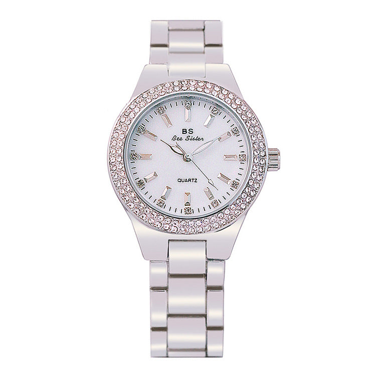 Gold tone watch with crystal bezel and link bracelet on wrist, view 3